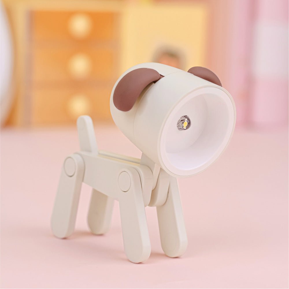 Lampe de bureau articulée en forme de chien de couleur beige avec abat-jour garni d'oreilles de couleur brun orangé. La figure est l'ampoule.