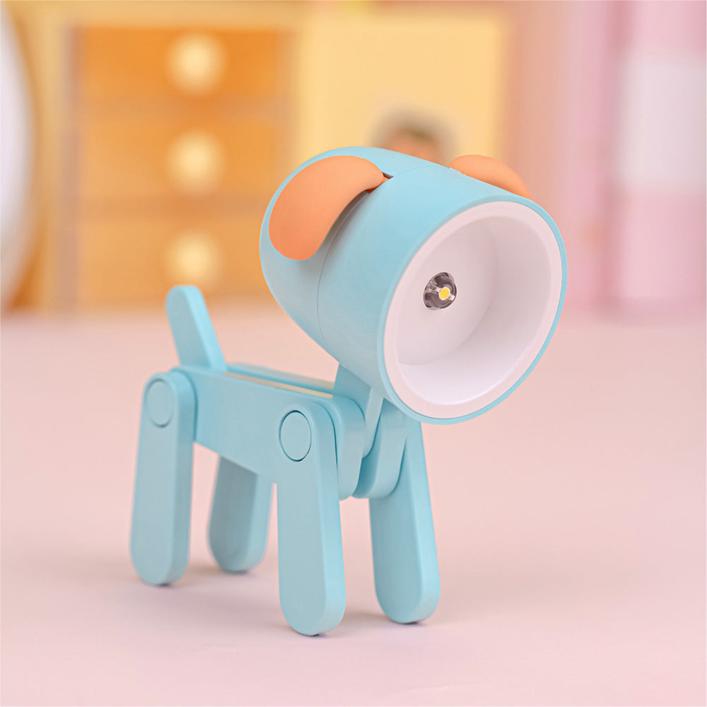 Lampe de bureau articulé en forme de chien de couleur bleue avec abat-jour garni d'oreilles de couleur orange. La figure est l'ampoule.