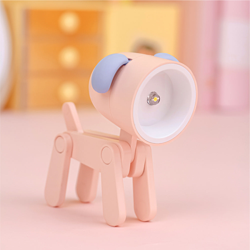 Lampe de bureau articulé en forme de chien de couleur rose avec abat-jour garni d'oreilles de couleur lilas. La figure est l'ampoule.