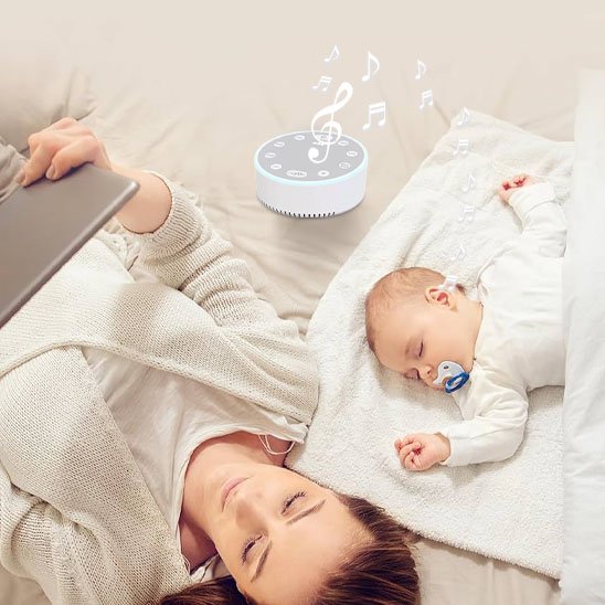 Un maman consulte sa tablette, couchée sur le dos à cÎté de son bébé endormi au son de la veilleuse bébé | SleepSerenity