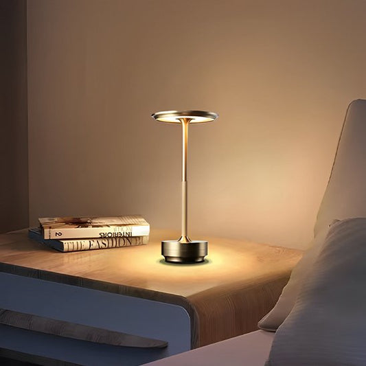 l'image montre la Lampe de table ModernTouch posée sur une table de chevet près de deux livres.