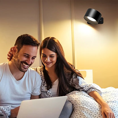 On voit un couple au lit qui regarde un ordinateur portable éclairés par l'applique murale chambre | Design Luminescence