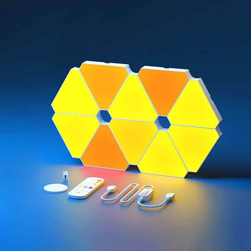 On voit 10 appliques murales interieur | Design Reuleaux illuminées en jaune et orange posée sur une surface et devant, tous les accessoires : câble, télécommande clé usb